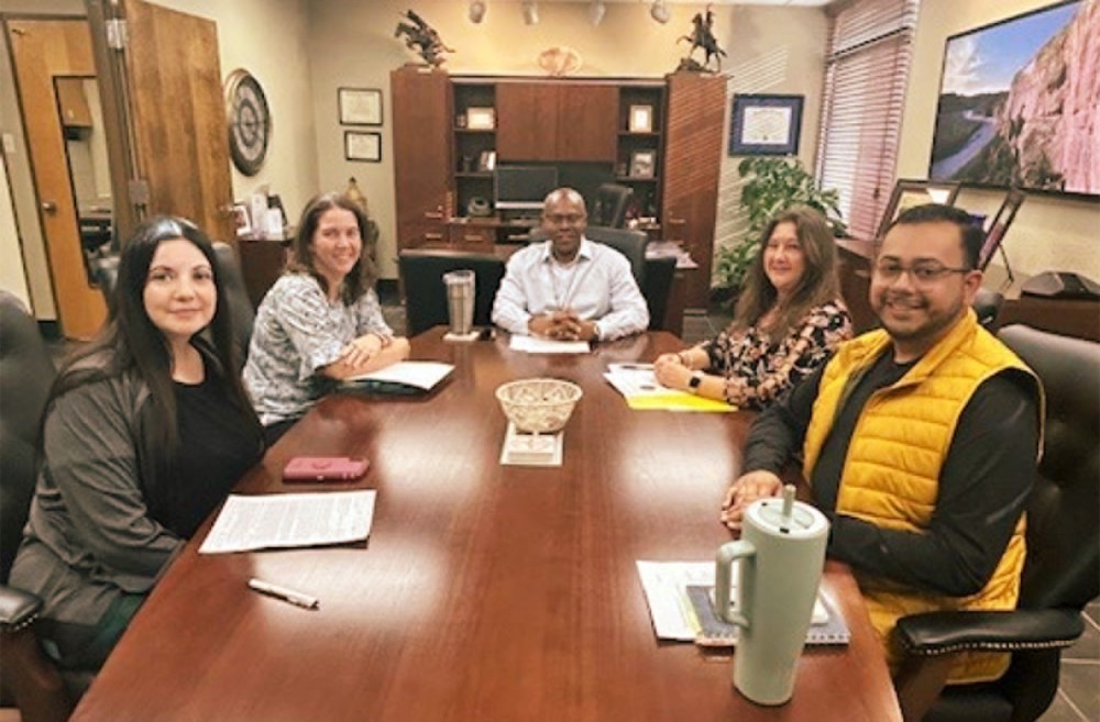 Cohort One - Group Two discussing year-two projects with Derek Moore, Ed.D.