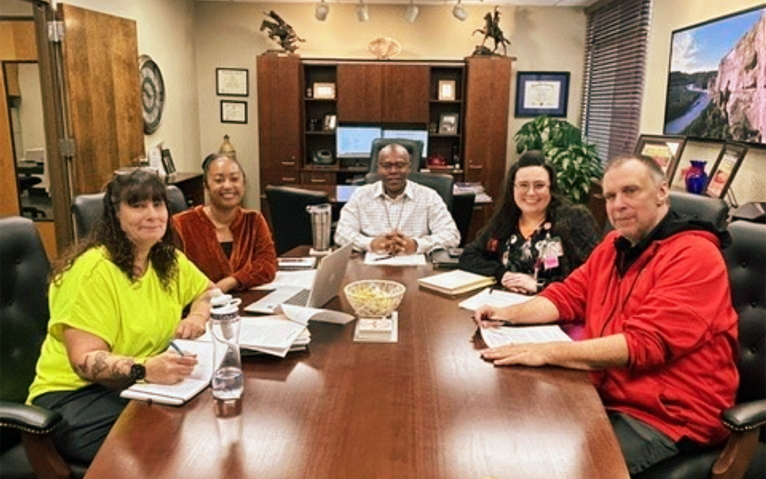 Cohort One - Group Three discussing year-two projects with Derek Moore, Ed.D.